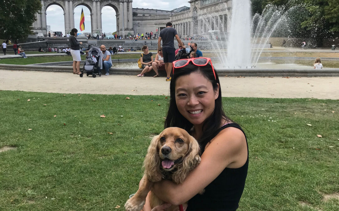 My dog, Malcolm, and myself sitting on the green grass in Parc du Cinquantenaire, Brussels one sunny day. The fountain and the Triumphal Arch are behind us.