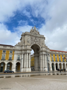 This travel guide to Lisbon includes the arch in Praça do Comércio, pictured with very few people around.