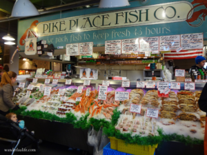 Fish and crabs on ice at Pike Place Fish Co. in the Public Market in a walkable Seattle. 