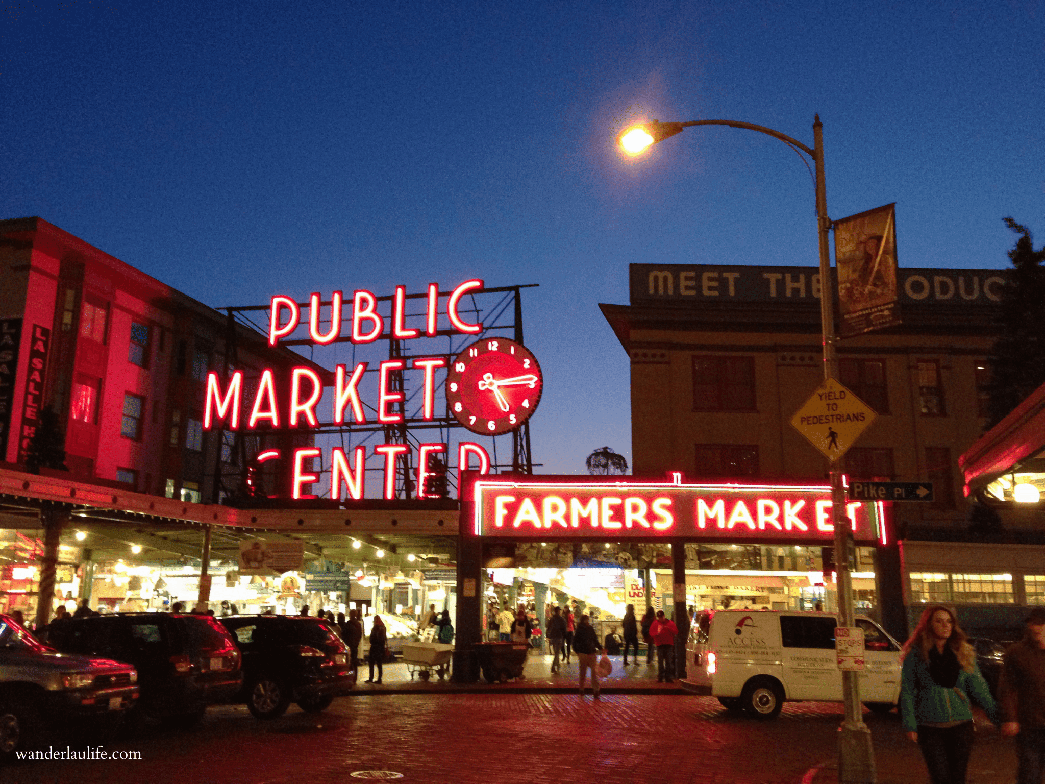 The Public Market Center main entrance and sign lit up for the evening in a walkable Seattle itinerary.