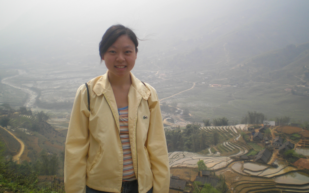 Me, standing in front of distant rice paddies in rural Vietnam on a foggy day.