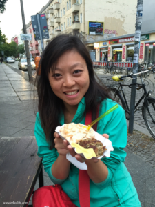 Me enjoying food from one of the many snack stands in Berlin.