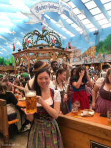 Me in my dirndl holding a very large glass of beer at Oktoberfest.