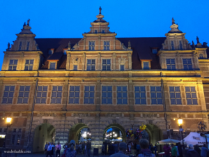 The lit up Green Gate at night is one of the best sights to see in Gdańsk. 