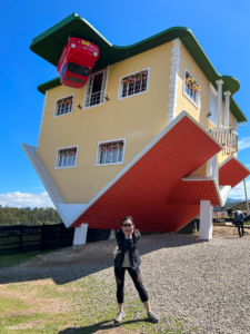 Me standing outside the upside-down house of La Casaloca, a day trip from Bogotá.